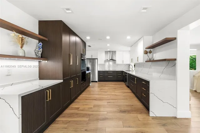 a large kitchen with stainless steel appliances kitchen island granite countertop a large counter top stainless steel appliances and cabinets