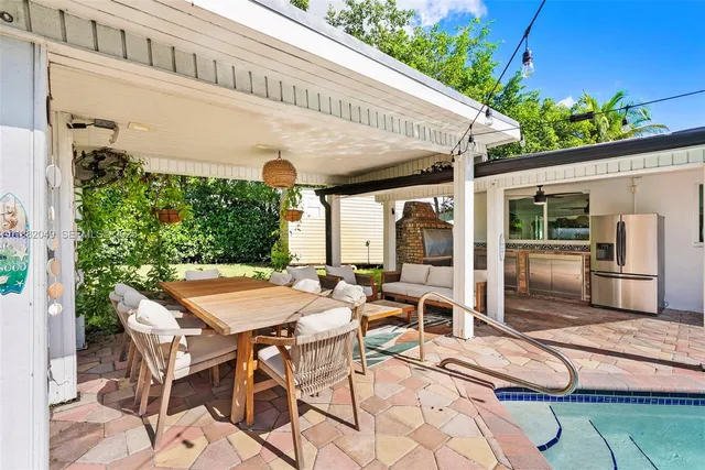 a view of a patio with table and chairs and potted plants