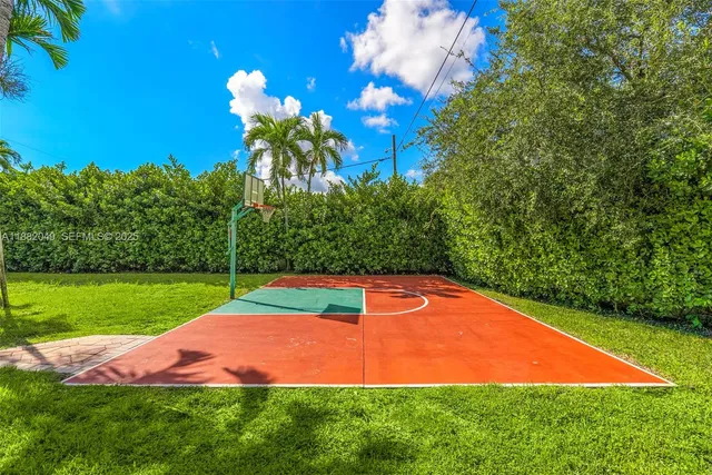 a view of a backyard with a garden and entertaining space