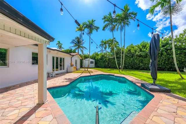 a view of swimming pool with palm trees