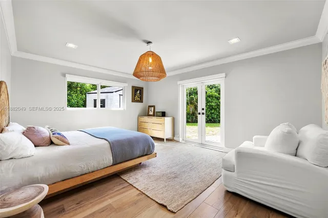 a bedroom with a large bed and a large window