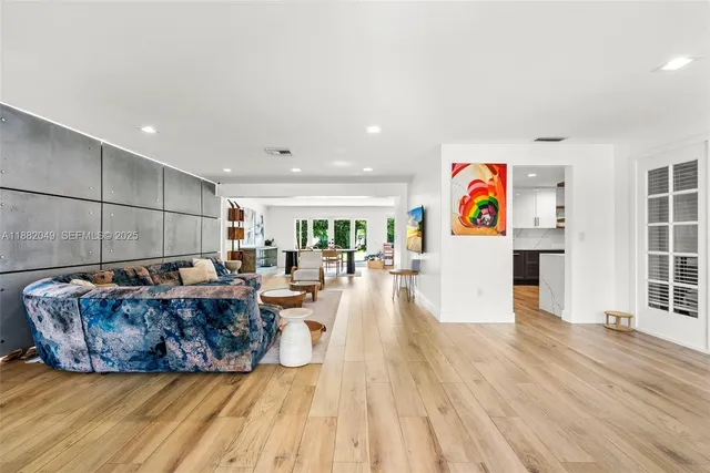 a living room with furniture and a wooden floor