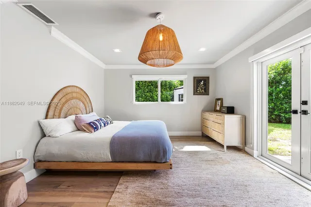 a bedroom with bed and a large window