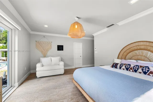 a bedroom with a bed and a potted plant