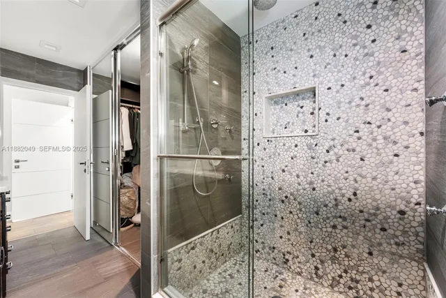 a bathroom with a shower and a sink