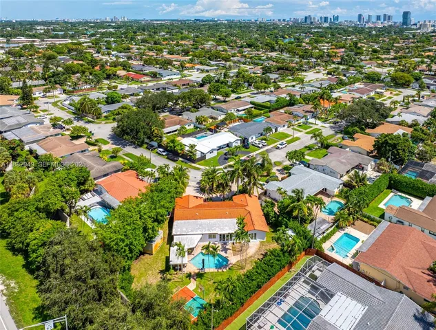 an aerial view of residential houses with outdoor space and street view