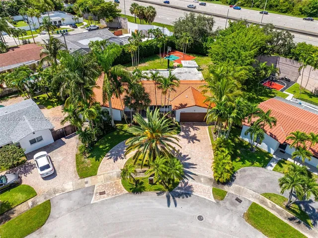 an aerial view of a house with a yard and garden