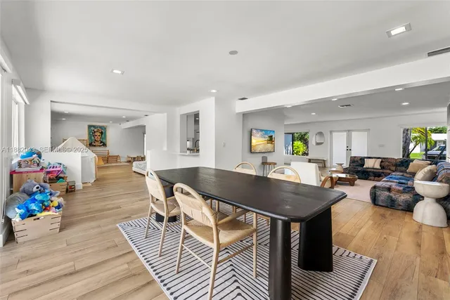 a living room with dining room and wooden floor
