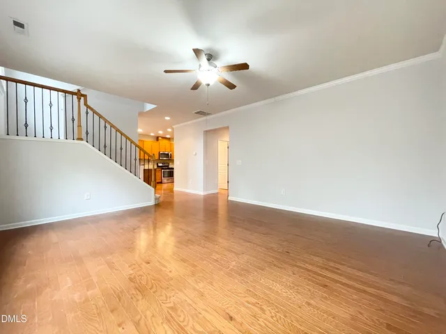 a view of a room with wooden floor