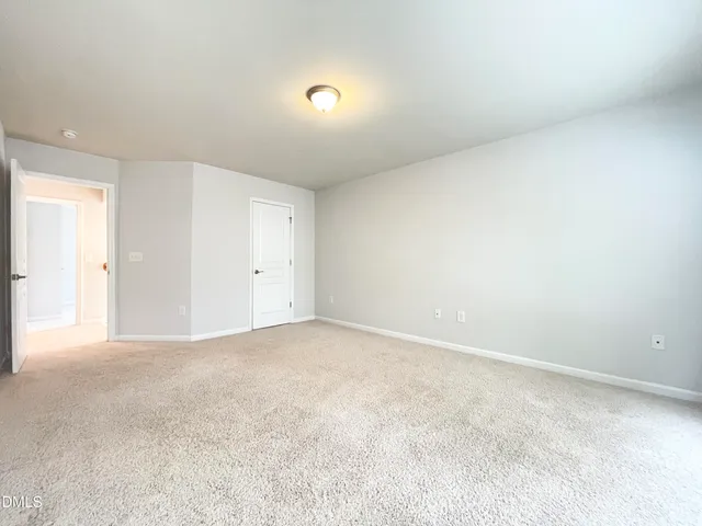 a view of an empty room and a window