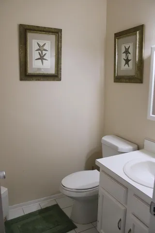 a white toilet sitting next to a white walls