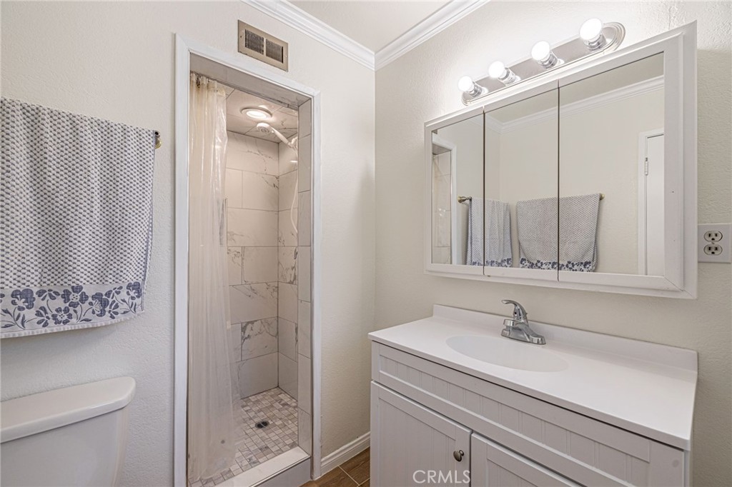 44916 18th Street West Lancaster, CA 93534 - Photo 17 of 32 a bathroom with a sink a toilet and shower
