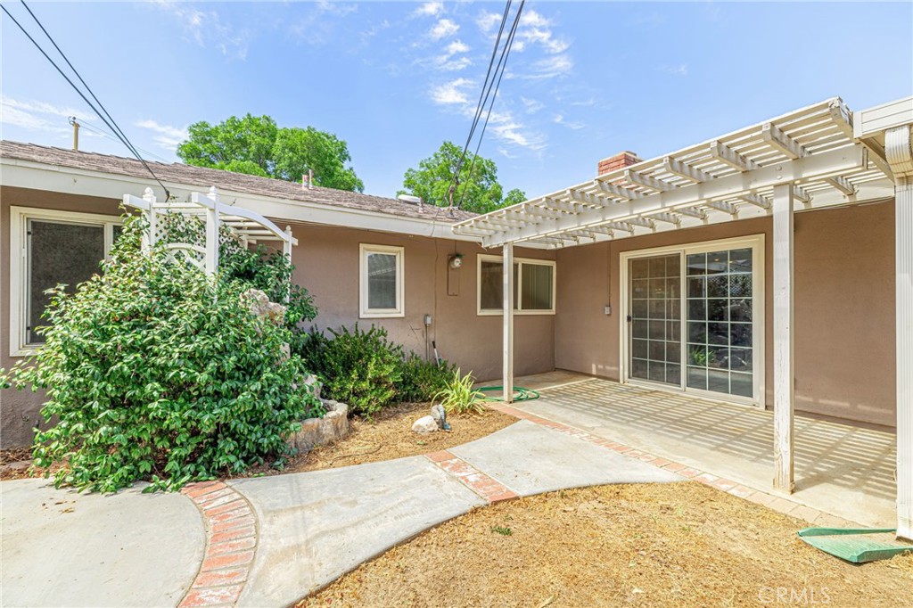 44916 18th Street West Lancaster, CA 93534 - Photo 29 of 32 a front view of a house with a yard and potted plants