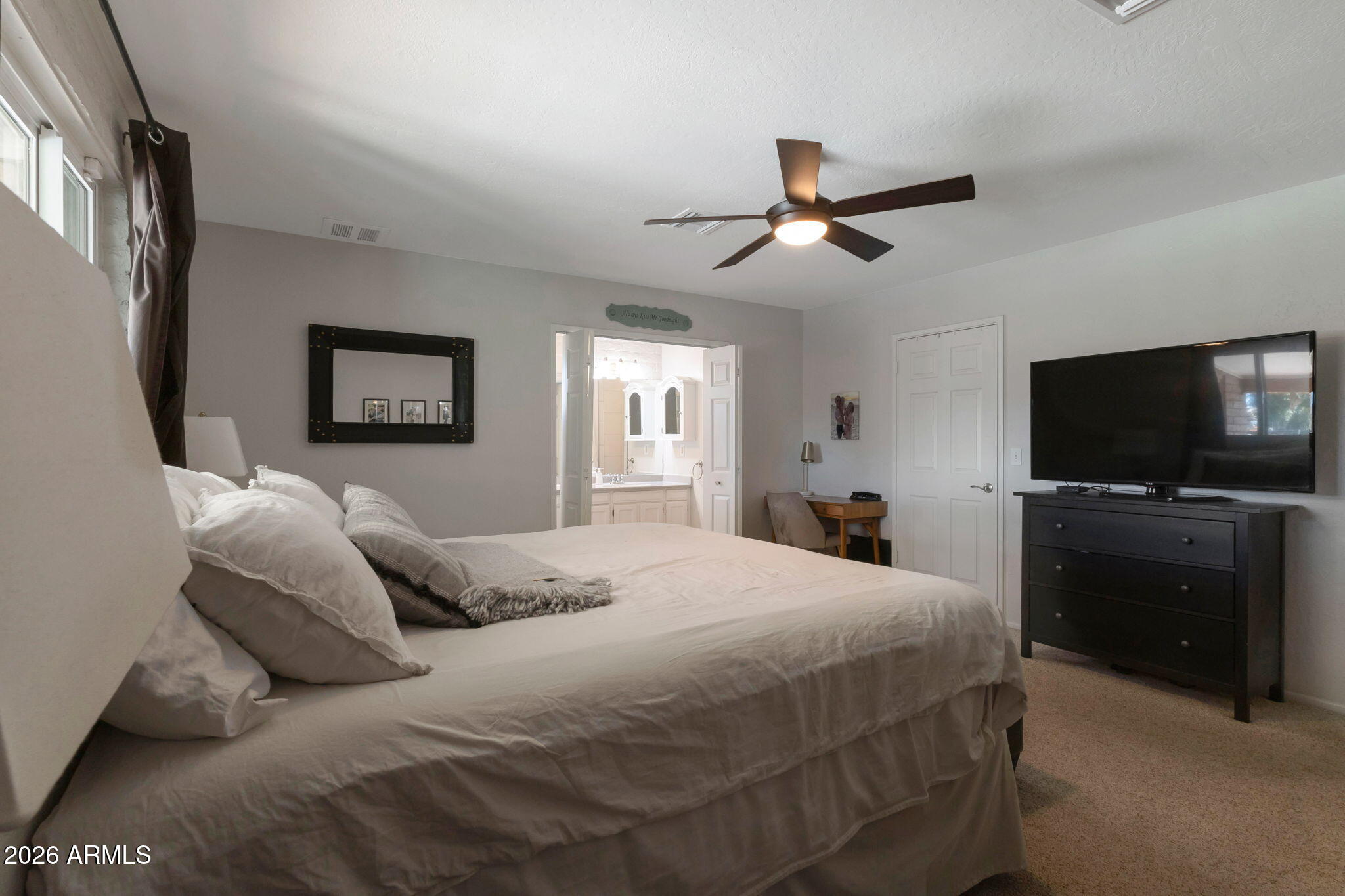 4546 North 34th Place Phoenix, AZ 85018 - Photo 14 of 29 a bedroom with a bed and a flat screen tv