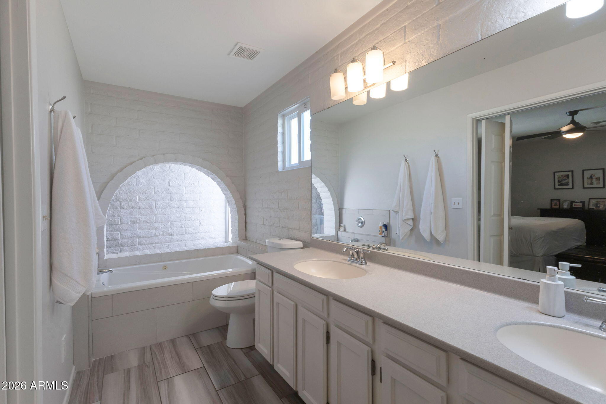 4546 North 34th Place Phoenix, AZ 85018 - Photo 15 of 29 a bathroom with a double vanity sink toilet and a mirror