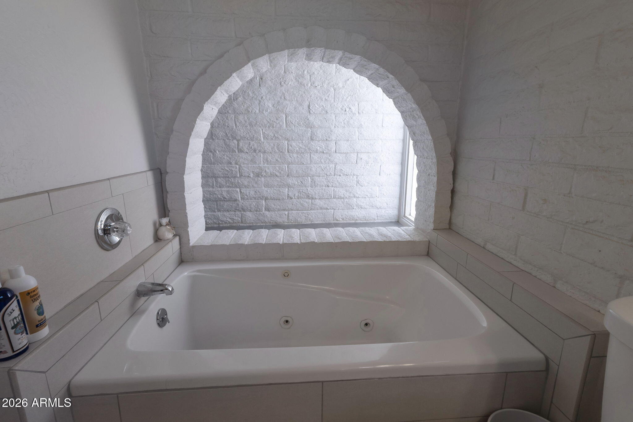 4546 North 34th Place Phoenix, AZ 85018 - Photo 16 of 29 a bathroom with a tub and shower