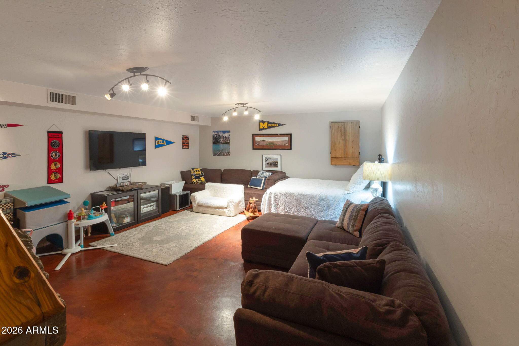 4546 North 34th Place Phoenix, AZ 85018 - Photo 21 of 29 a living room with furniture and a flat screen tv