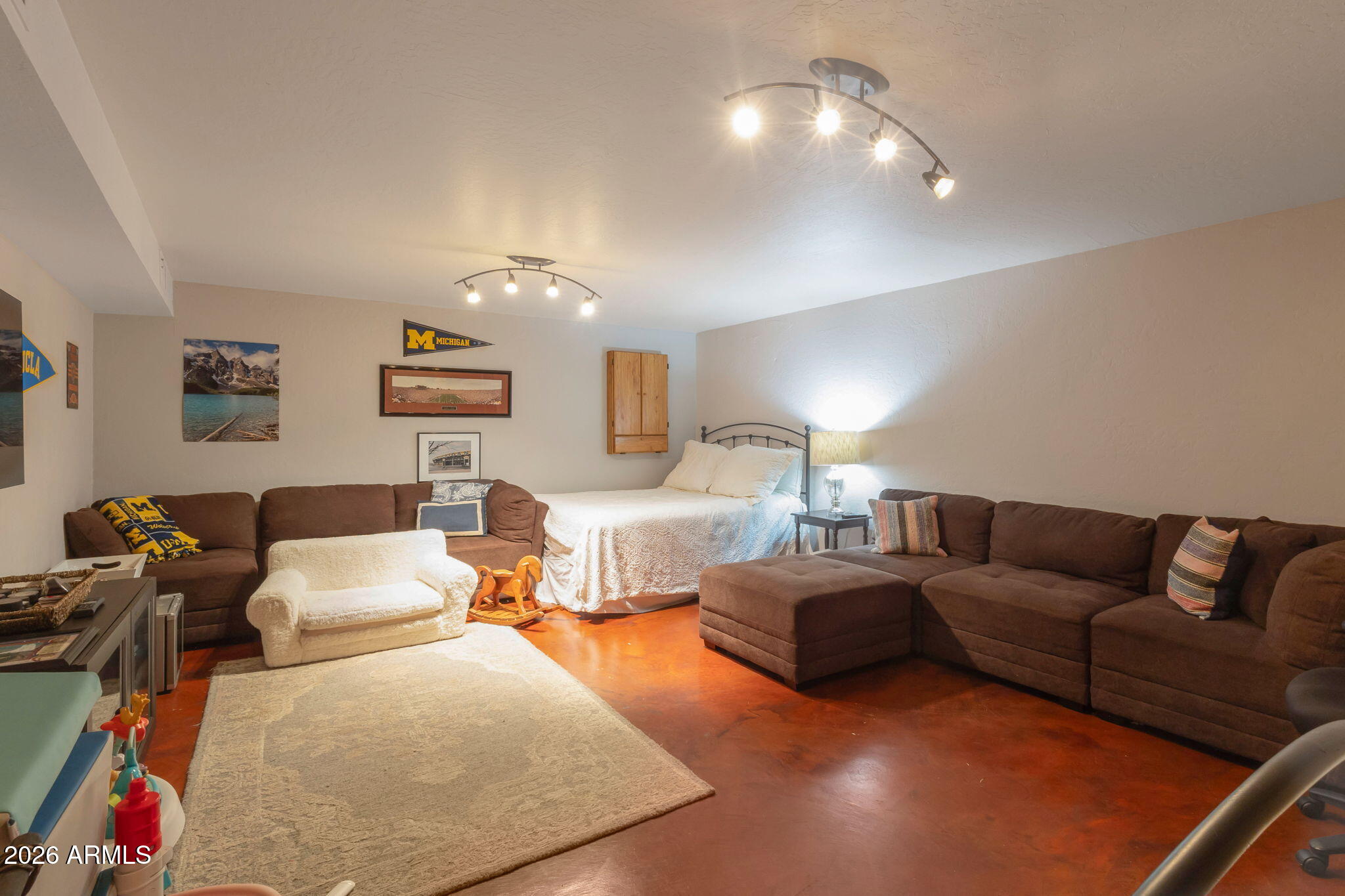 4546 North 34th Place Phoenix, AZ 85018 - Photo 22 of 29 a living room with furniture and a chandelier