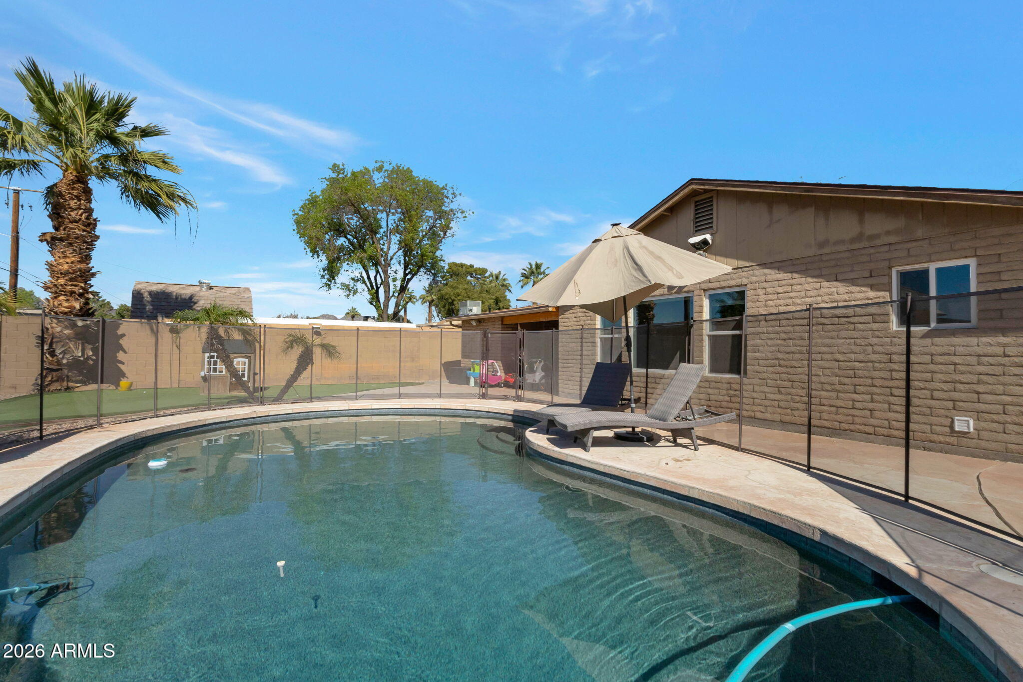 4546 North 34th Place Phoenix, AZ 85018 - Photo 26 of 29 a swimming pool with outdoor seating and yard