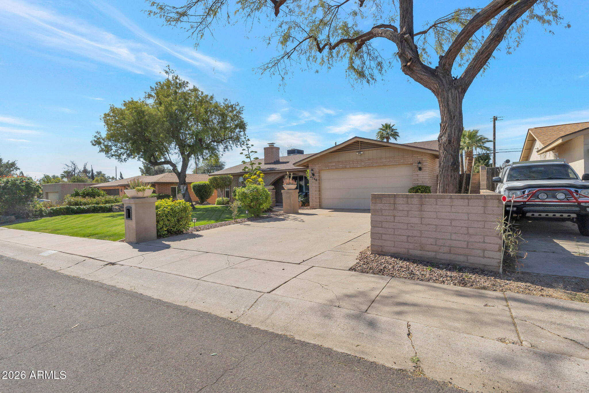 4546 North 34th Place Phoenix, AZ 85018 - Photo 3 of 29 a view of a house with a cars park side of a road