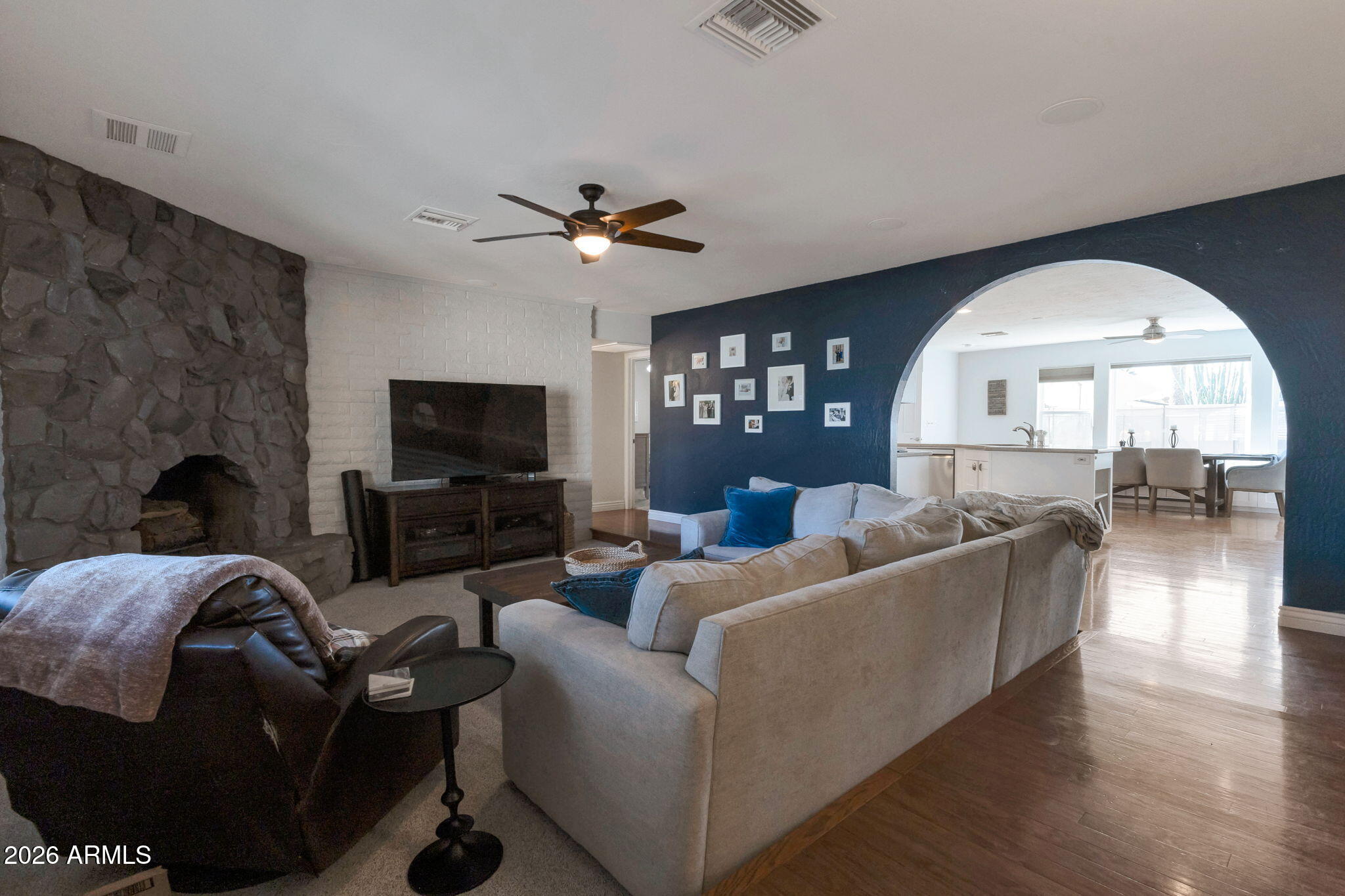 4546 North 34th Place Phoenix, AZ 85018 - Photo 6 of 29 a living room with furniture a fireplace and a flat screen tv