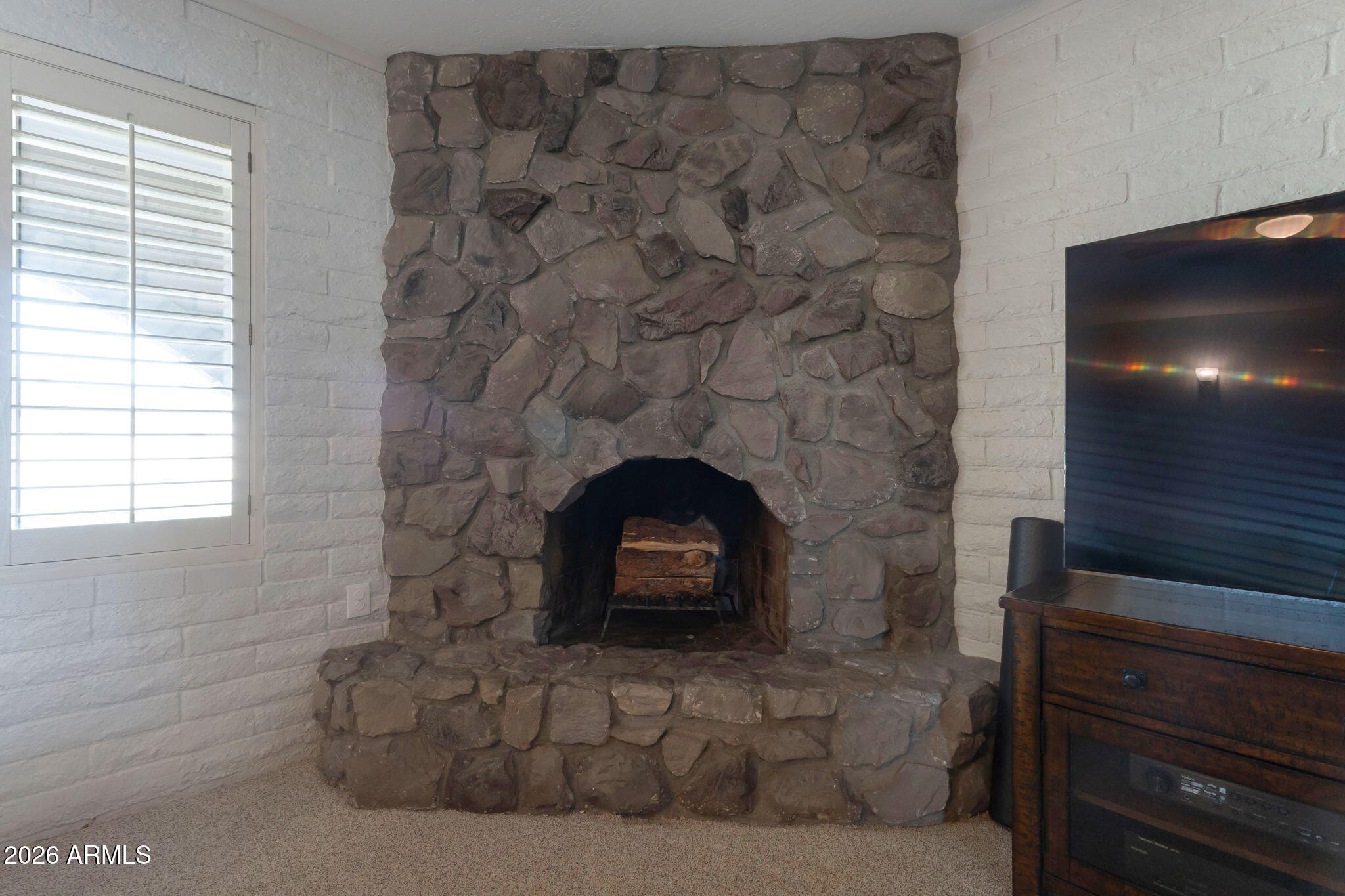 4546 North 34th Place Phoenix, AZ 85018 - Photo 7 of 29 a living room with a fireplace