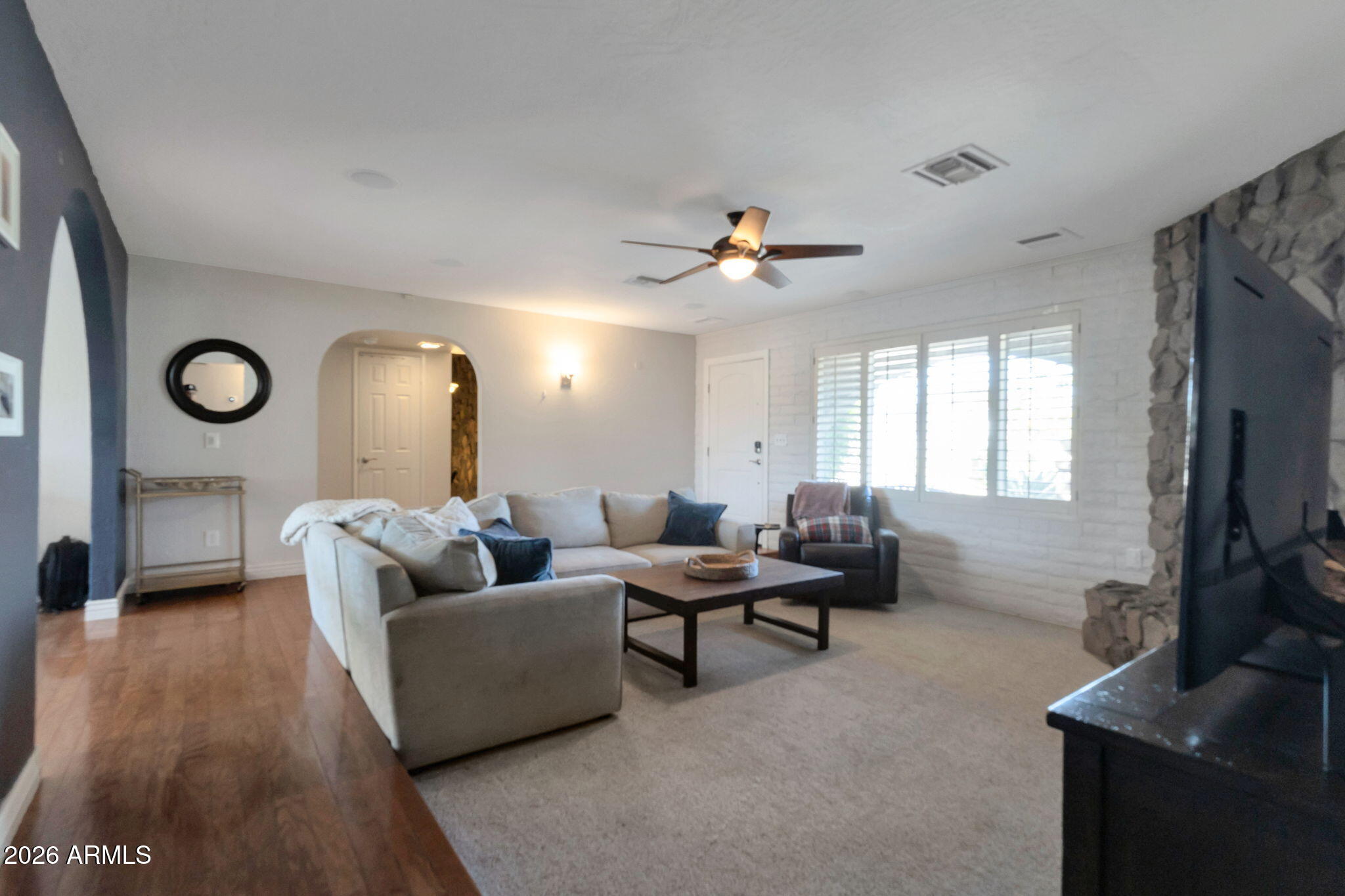 4546 North 34th Place Phoenix, AZ 85018 - Photo 8 of 29 a living room with furniture and a flat screen tv