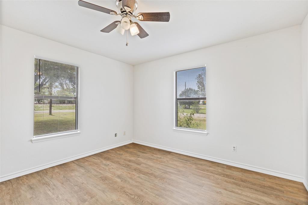 420 South Riggins Street Anna, TX 75409 - Photo 16 of 25 a view of an empty room with a window and wooden floor