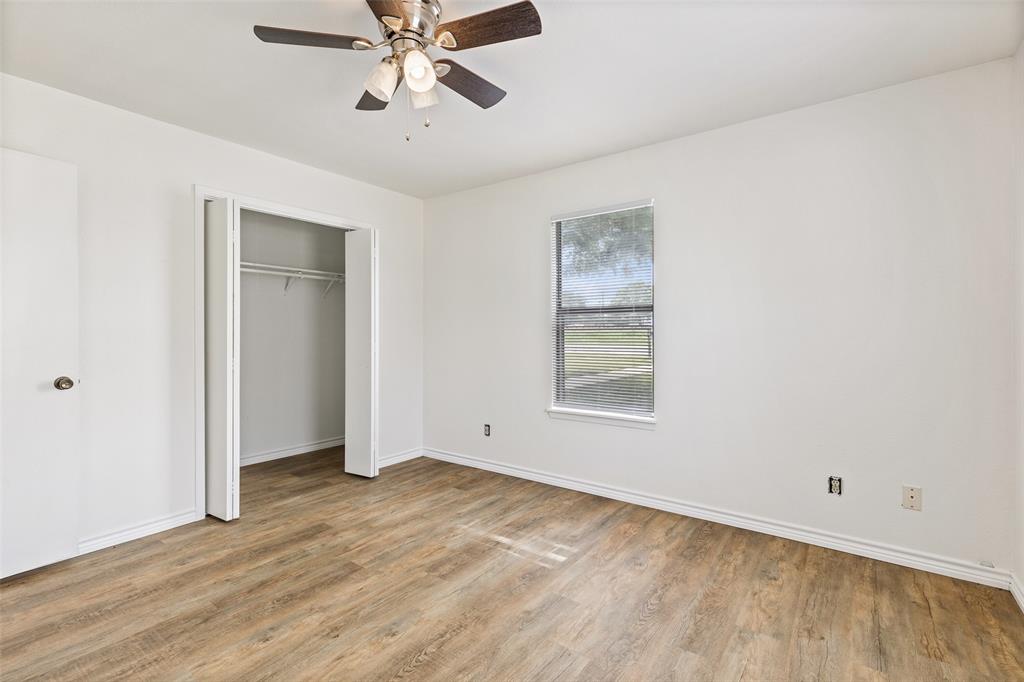 420 South Riggins Street Anna, TX 75409 - Photo 17 of 25 a view of an empty room with wooden floor and a window