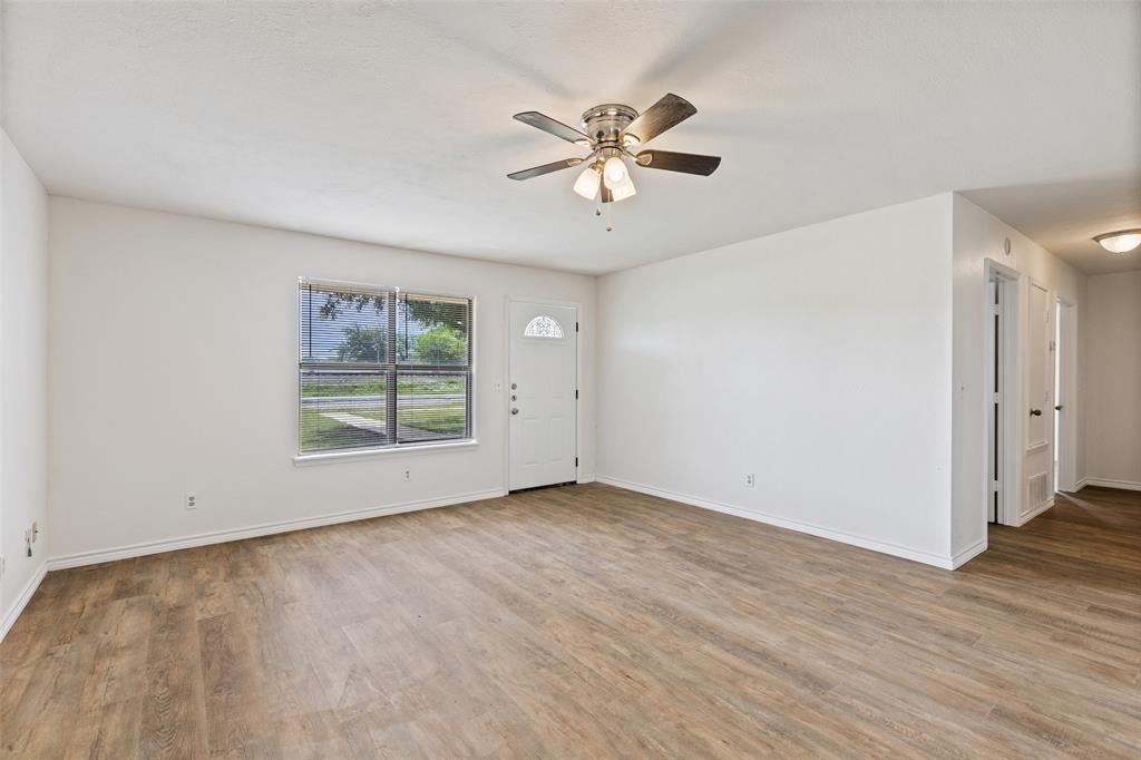 420 South Riggins Street Anna, TX 75409 - Photo 4 of 25 a view of an empty room with wooden floor and a window