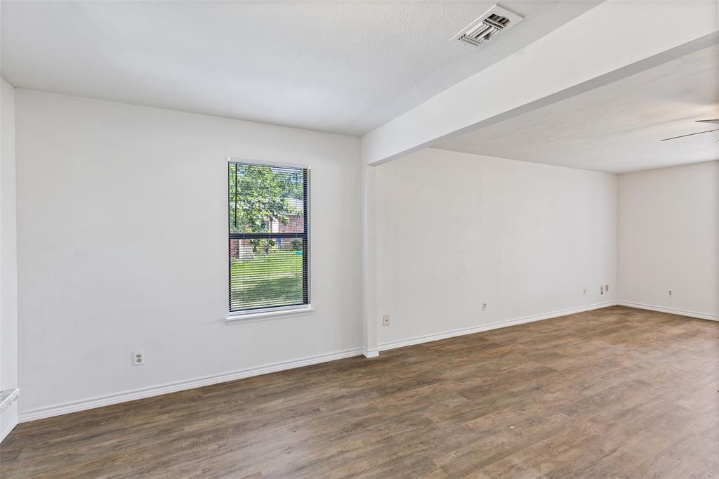 420 South Riggins Street Anna, TX 75409 - Photo 6 of 25 an empty room with wooden floor and window