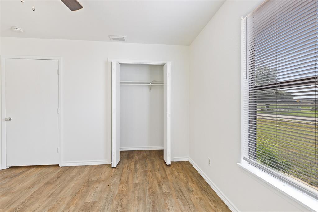 420 South Riggins Street Anna, TX 75409 - Photo 10 of 25 a view of an empty room with wooden floor and a window