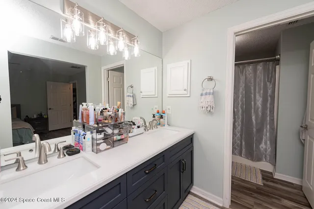 a bathroom with a double vanity sink and a mirror