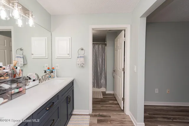 a bathroom with a sink a mirror and a shower