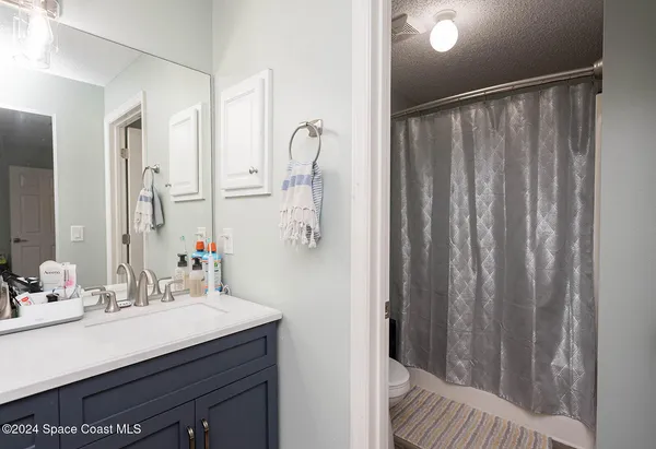 a bedroom with a bed and cabinet