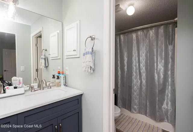 a bedroom with a bed and cabinet