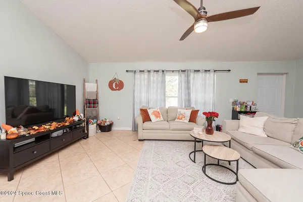 a kitchen with granite countertop a refrigerator and a stove top oven