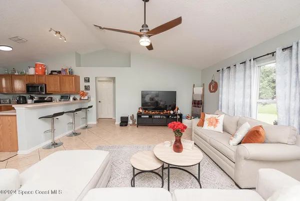 a kitchen with stainless steel appliances granite countertop a sink dishwasher and a refrigerator