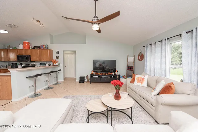 a kitchen with stainless steel appliances granite countertop a sink dishwasher and a refrigerator