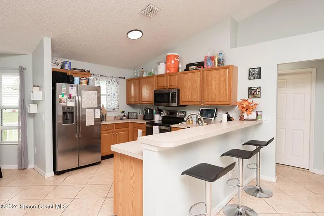 a dining room with furniture and a window