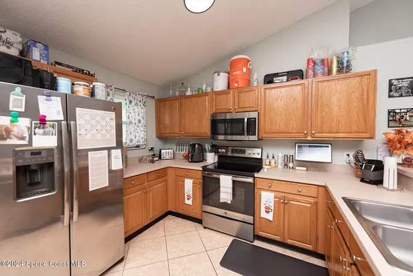 a kitchen with a sink and chairs