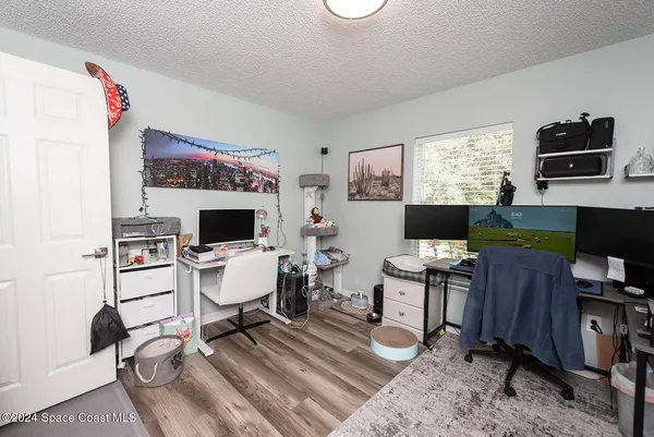 a living room with furniture a flat screen tv and a window