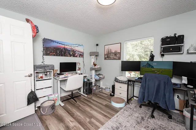 a living room with furniture a flat screen tv and a window