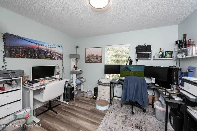 a workspace with furniture a bookshelf and a window