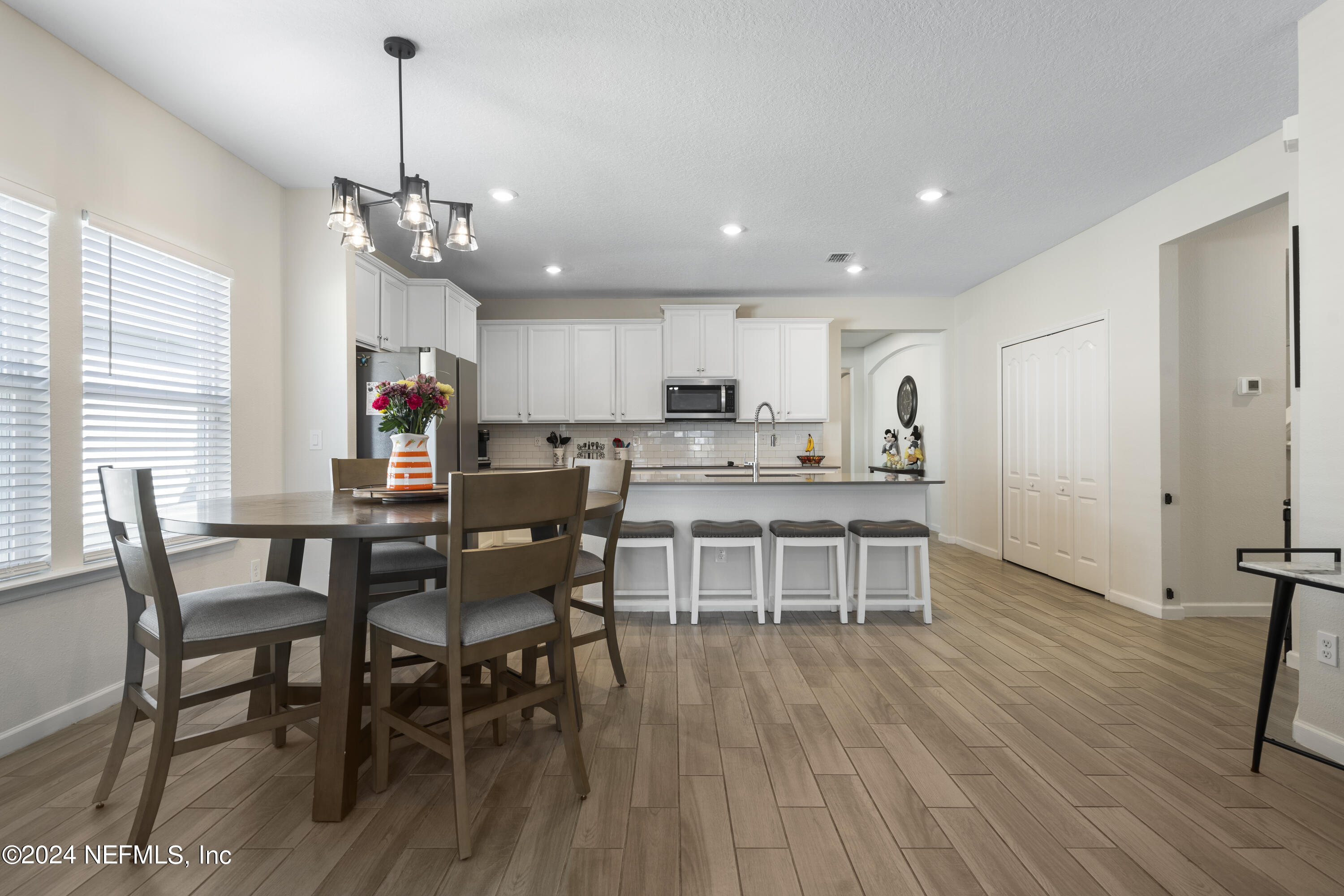 4060 Arbor Mill Circle Orange Park, FL 32065 - Photo 17 of 52 a view of a dining room with furniture window and wooden floor