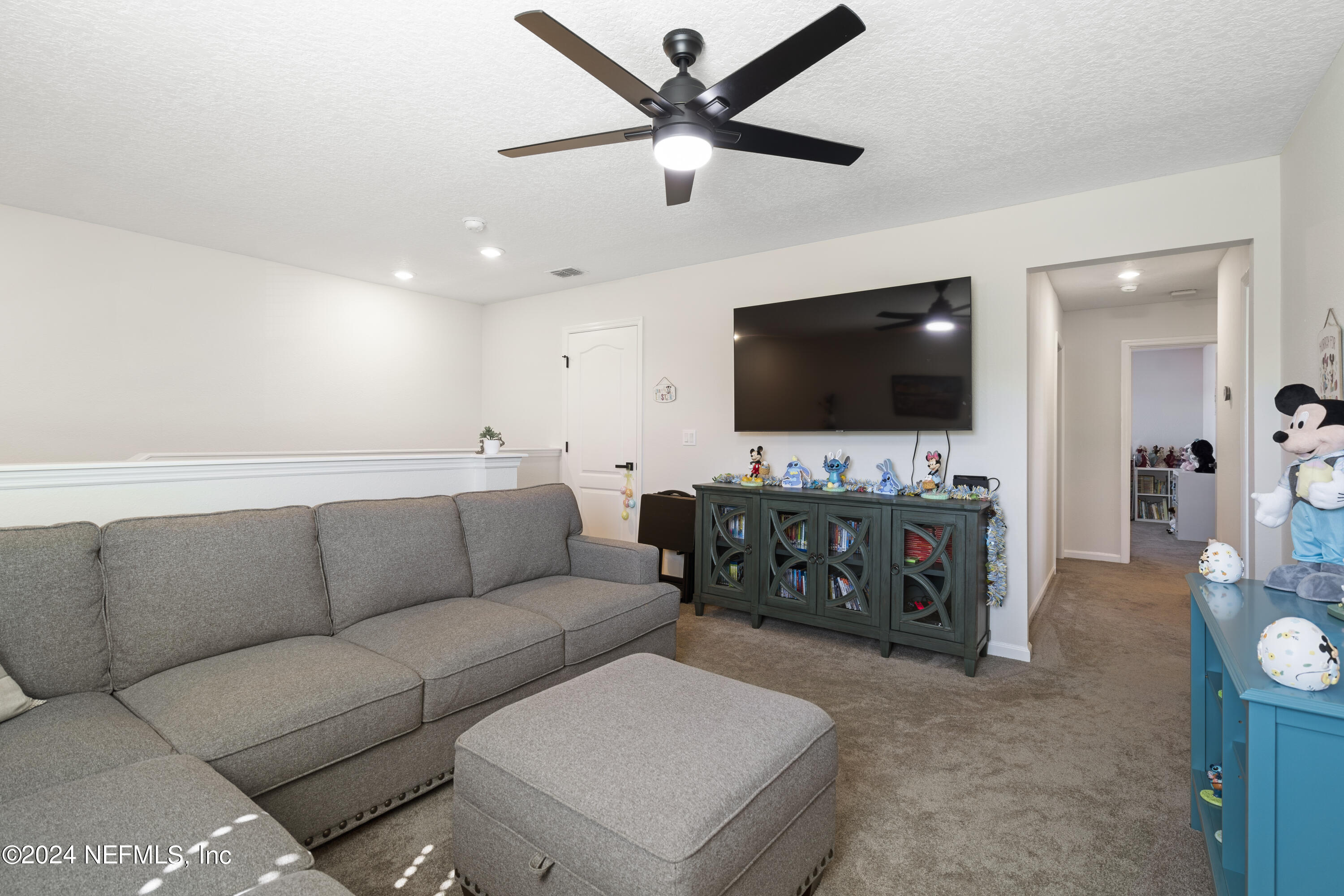 4060 Arbor Mill Circle Orange Park, FL 32065 - Photo 32 of 52 a living room with furniture and a flat screen tv