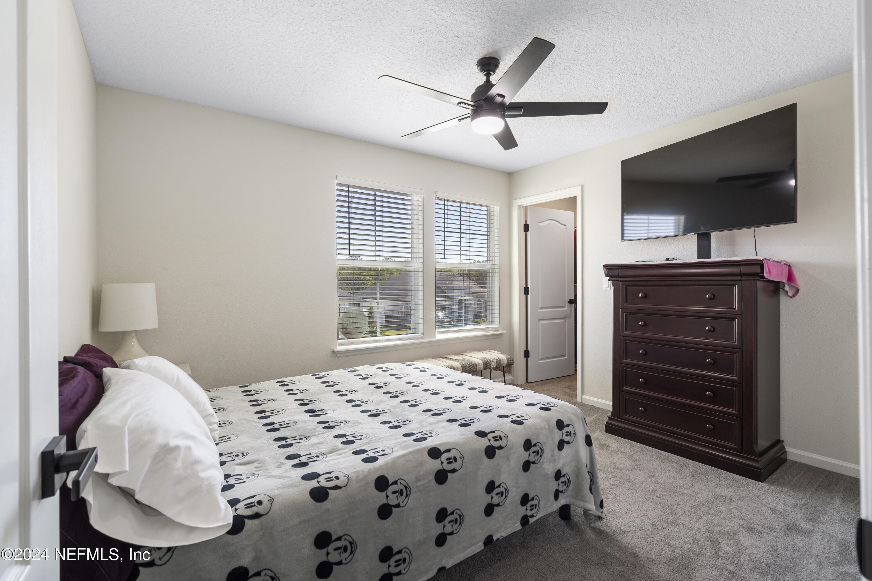 4060 Arbor Mill Circle Orange Park, FL 32065 - Photo 33 of 52 a bedroom with a bed and a flat screen tv