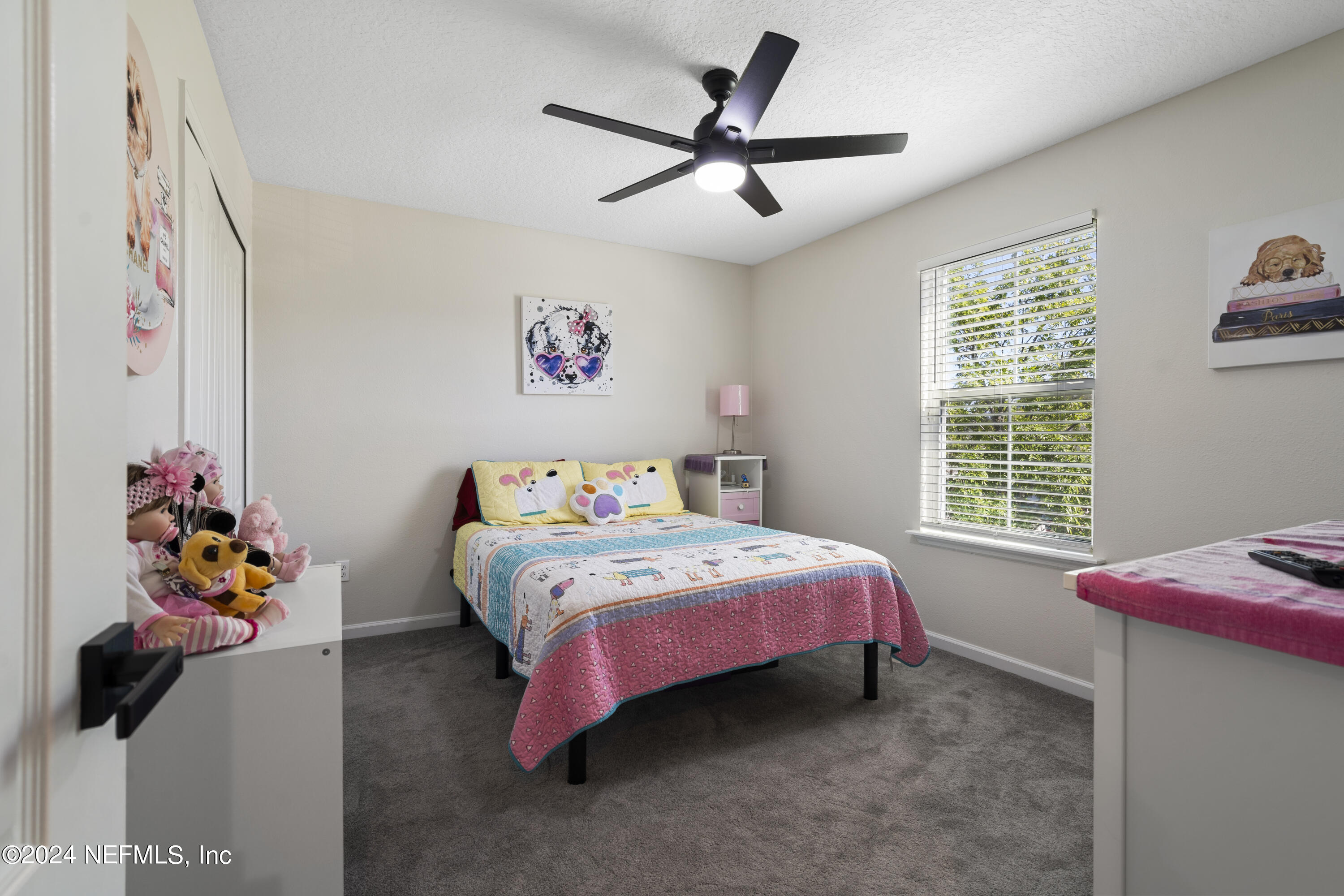 4060 Arbor Mill Circle Orange Park, FL 32065 - Photo 37 of 52 a bedroom with a bed and a chandelier