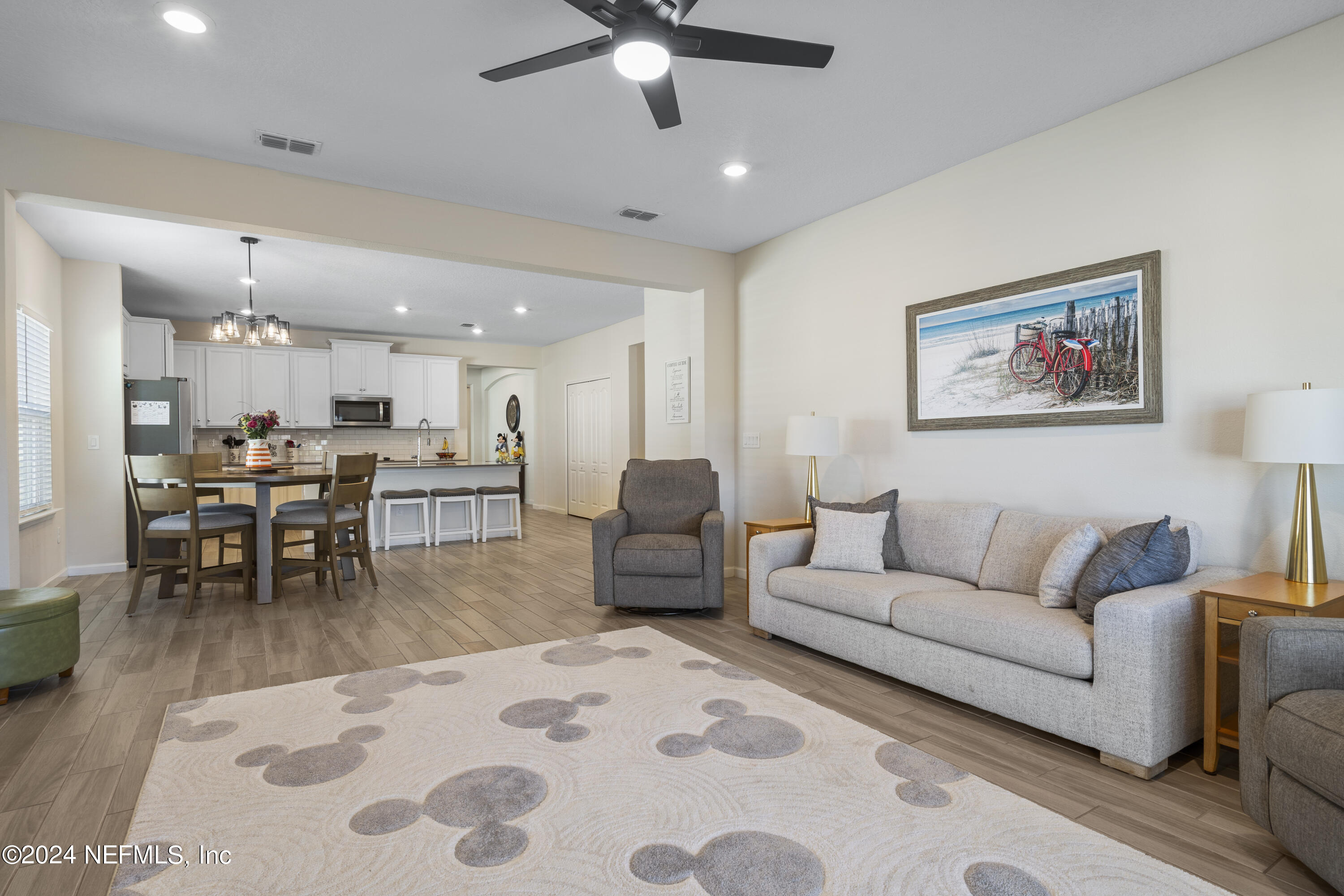 4060 Arbor Mill Circle Orange Park, FL 32065 - Photo 6 of 52 a living room with furniture and a dining table with kitchen view