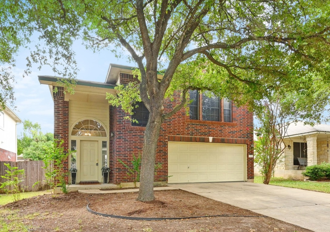 a front view of a house with a yard and garage